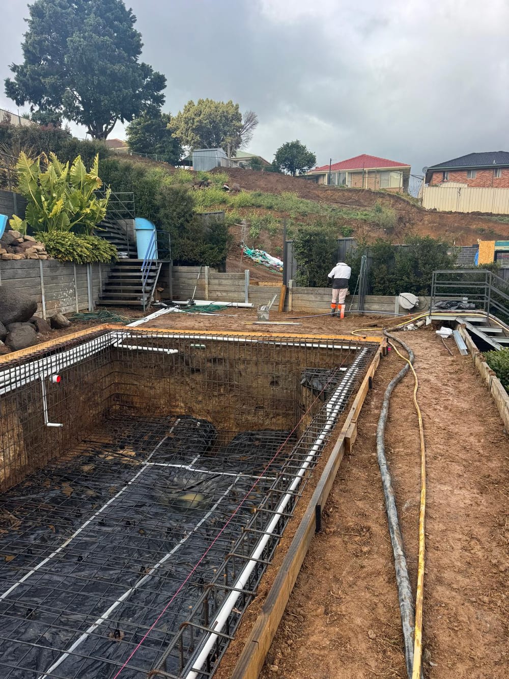 Pool steel cage and plumbing on a terraced, sloping block