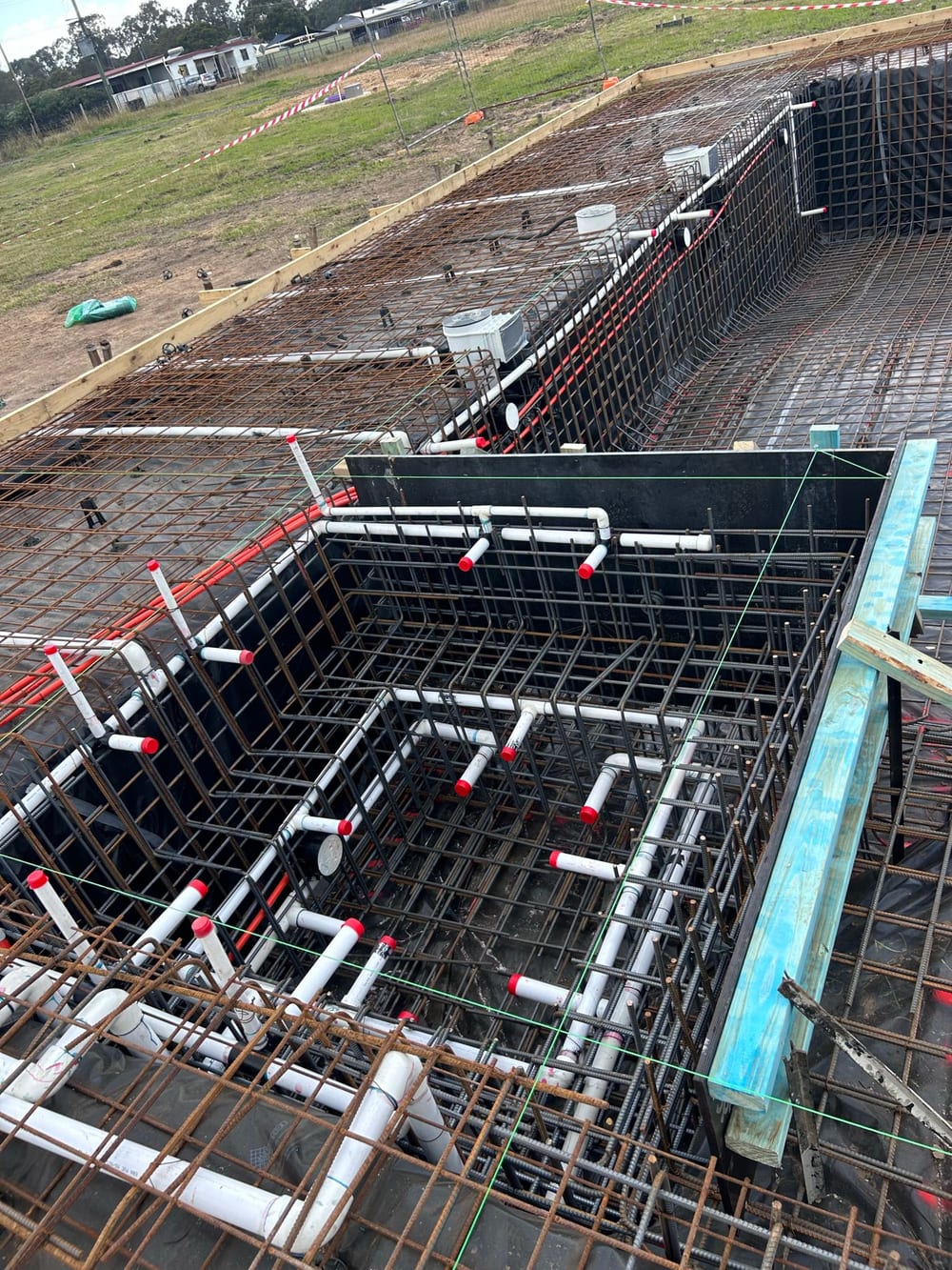 Pool and spa steel reinforcement with capped plumbing lines, set out to the design on a Nabilton Group site