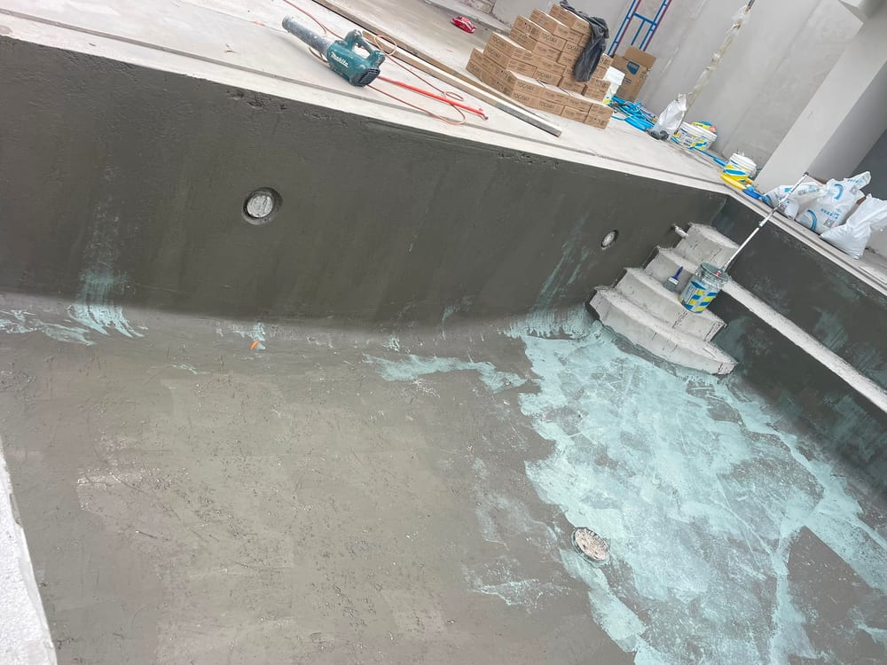 Waterproofed pool shell with curved entry steps and light niches